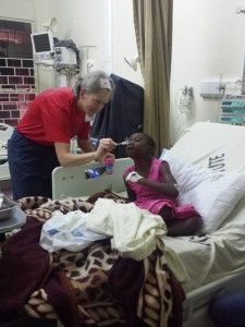 Pediatric intensivist Dr. Jen Schuette playing with post-cath patient