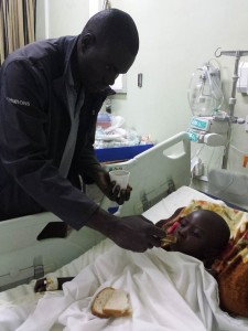 Father feeding daughter after her cath procedure