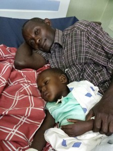 Patient and her father in her hospital bed